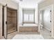Primary bathroom featuring a glass shower, soaking tub, and a separate toilet room at 2423 Rosapenna Nw Ln, Kennesaw, GA 30152