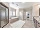 Primary bathroom with double sink vanity, soaking tub, and glass door walk-in shower at 2423 Rosapenna Nw Ln, Kennesaw, GA 30152