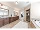 Primary bathroom with double sink vanity, soaking tub, and glass door walk-in shower at 2423 Rosapenna Nw Ln, Kennesaw, GA 30152