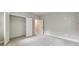 Neutral-colored bedroom with plush carpet, open double-door closet, and view to another room at 2423 Rosapenna Nw Ln, Kennesaw, GA 30152