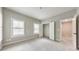 Bright bedroom with neutral paint, two windows with shutter blinds, plush carpet, and double door closet at 2423 Rosapenna Nw Ln, Kennesaw, GA 30152