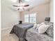Cozy bedroom features plush carpeting, plantation shutters, and a comfortable bed, creating a tranquil personal space at 2423 Rosapenna Nw Ln, Kennesaw, GA 30152