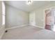 Neutral bedroom featuring carpet, double door closet, and view to hallway with wood floors at 2423 Rosapenna Nw Ln, Kennesaw, GA 30152