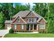 Beautiful brick home with a well-manicured lawn and lush green trees providing ample shade at 2423 Rosapenna Nw Ln, Kennesaw, GA 30152