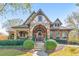 Charming home exterior featuring stone accents, a covered porch, and manicured landscaping at 2423 Rosapenna Nw Ln, Kennesaw, GA 30152
