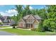 Imposing brick two-story home with well-kept landscaping on a sunny day at 2423 Rosapenna Nw Ln, Kennesaw, GA 30152