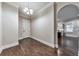 Hallway featuring hardwood floors, neutral paint, and classic white trim, connecting various rooms within the home at 2423 Rosapenna Nw Ln, Kennesaw, GA 30152