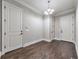 Hallway featuring hardwood floors, neutral paint, and classic white trim, connecting various rooms within the home at 2423 Rosapenna Nw Ln, Kennesaw, GA 30152