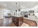 Bright kitchen features stainless appliances, a granite island, and opens to the living room, creating an inviting space at 2423 Rosapenna Nw Ln, Kennesaw, GA 30152