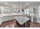 A kitchen featuring granite countertops, modern appliances, and a central island illuminated by pendant lighting at 2423 Rosapenna Nw Ln, Kennesaw, GA 30152