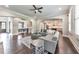 Open-concept living room with hardwood floors, a gray sofa and an archway to the kitchen and dining room at 2423 Rosapenna Nw Ln, Kennesaw, GA 30152