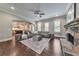 Cozy living room with stone fireplace, hardwood floors, and an archway to the kitchen at 2423 Rosapenna Nw Ln, Kennesaw, GA 30152