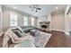 Comfortable living room featuring a stone fireplace, hardwood floors and three large windows at 2423 Rosapenna Nw Ln, Kennesaw, GA 30152
