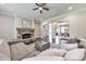 Spacious living room featuring hardwood floors, stone fireplace and an open design to the dining room at 2423 Rosapenna Nw Ln, Kennesaw, GA 30152