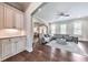 Open living room with hardwood floors, a comfortable couch, and an archway to the kitchen at 2423 Rosapenna Nw Ln, Kennesaw, GA 30152