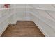 Walk-in pantry with wire shelving and hardwood flooring, offering abundant storage space for all your kitchen essentials at 2423 Rosapenna Nw Ln, Kennesaw, GA 30152