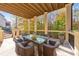Inviting patio with a dining table, chairs, and a view of the surrounding woods at 2423 Rosapenna Nw Ln, Kennesaw, GA 30152