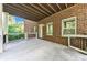 Large outdoor patio area featuring stained wood ceilings and classic brick accents at 2423 Rosapenna Nw Ln, Kennesaw, GA 30152