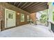 Covered patio with stained wood ceiling, brick wall and black metal railing at 2423 Rosapenna Nw Ln, Kennesaw, GA 30152
