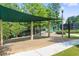A covered playground area with swings and slides offers a fun space for children to play at 2423 Rosapenna Nw Ln, Kennesaw, GA 30152