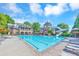 A sparkling pool with a water slide and lounge chairs is surrounded by a beautiful brick clubhouse at 2423 Rosapenna Nw Ln, Kennesaw, GA 30152