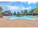 An inviting swimming pool, splash pad and shaded seating area create a relaxing retreat at 2423 Rosapenna Nw Ln, Kennesaw, GA 30152