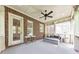 Cozy back porch with ceiling fan, brick wall and comfortable seating, perfect for relaxation at 2423 Rosapenna Nw Ln, Kennesaw, GA 30152