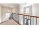 Staircase with wood railing and wrought iron spindles leading to a view of the front door at 2423 Rosapenna Nw Ln, Kennesaw, GA 30152