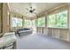 Bright sunroom with ample natural light, a ceiling fan, and comfortable seating, ideal for relaxation and enjoying the view at 2423 Rosapenna Nw Ln, Kennesaw, GA 30152