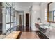 Contemporary bathroom boasts a floating vanity, frameless shower with tile flooring, and large windows at 3184 Wood Valley Nw Rd, Atlanta, GA 30327