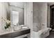Modern bathroom with a soaking tub, sleek vanity, and patterned tile flooring at 3184 Wood Valley Nw Rd, Atlanta, GA 30327