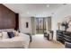 Bright bedroom boasts modern decor, a plush bed, accent chair, and a large window offering an outdoor view at 3184 Wood Valley Nw Rd, Atlanta, GA 30327