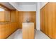 Walk-in closet with custom wood shelving and a granite-topped center island for optimal storage and organization at 3184 Wood Valley Nw Rd, Atlanta, GA 30327