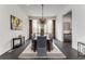 Elegant dining room featuring a modern chandelier, long table, and decor at 3184 Wood Valley Nw Rd, Atlanta, GA 30327