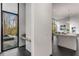 Modern entryway leading to a kitchen with large windows and sleek design elements at 3184 Wood Valley Nw Rd, Atlanta, GA 30327