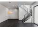 Modern entryway with dark tile flooring, a floating staircase, and contemporary lighting fixtures at 3184 Wood Valley Nw Rd, Atlanta, GA 30327