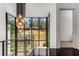 Staircase with dark hardwood floors and an overhead modern light fixture with a large glass window at 3184 Wood Valley Nw Rd, Atlanta, GA 30327