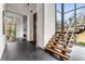 Elegant foyer features a modern staircase, fireplace, and expansive windows, creating an open and airy ambiance at 3184 Wood Valley Nw Rd, Atlanta, GA 30327