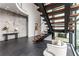 Stylish foyer features a modern staircase, sleek console table, and decorative art, enhancing the home's sophisticated design at 3184 Wood Valley Nw Rd, Atlanta, GA 30327