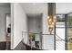 Upstairs hallway with modern railing and chandelier at 3184 Wood Valley Nw Rd, Atlanta, GA 30327