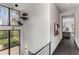 Upper staircase landing with modern art and outside views at 3184 Wood Valley Nw Rd, Atlanta, GA 30327