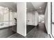 Hallway featuring black tile, glass walls, and views of the exercise room and stairs at 3184 Wood Valley Nw Rd, Atlanta, GA 30327