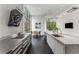Open concept kitchen with stainless steel countertops, sleek hood, and floor-to-ceiling windows at 3184 Wood Valley Nw Rd, Atlanta, GA 30327