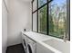 Bright laundry room with sink, folding counter, and large window at 3184 Wood Valley Nw Rd, Atlanta, GA 30327