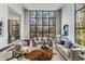 Open living room featuring high ceilings, large windows, and stylish furnishings for comfortable entertaining at 3184 Wood Valley Nw Rd, Atlanta, GA 30327