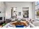 Bright living room with a fireplace, hardwood floors, and large windows offering views of the backyard at 3184 Wood Valley Nw Rd, Atlanta, GA 30327