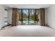 Serene living room with pool view from large windows, complete with stylish curtains at 3184 Wood Valley Nw Rd, Atlanta, GA 30327