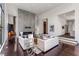 Inviting living room featuring hardwood floors, elegant decor, a floor to ceiling fireplace, and ample natural light at 3184 Wood Valley Nw Rd, Atlanta, GA 30327