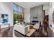 Bright and open living room with a floor to ceiling fireplace and expansive backyard views at 3184 Wood Valley Nw Rd, Atlanta, GA 30327