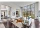 Spacious living room with floor-to-ceiling windows, a modern staircase, and an open-concept design at 3184 Wood Valley Nw Rd, Atlanta, GA 30327
